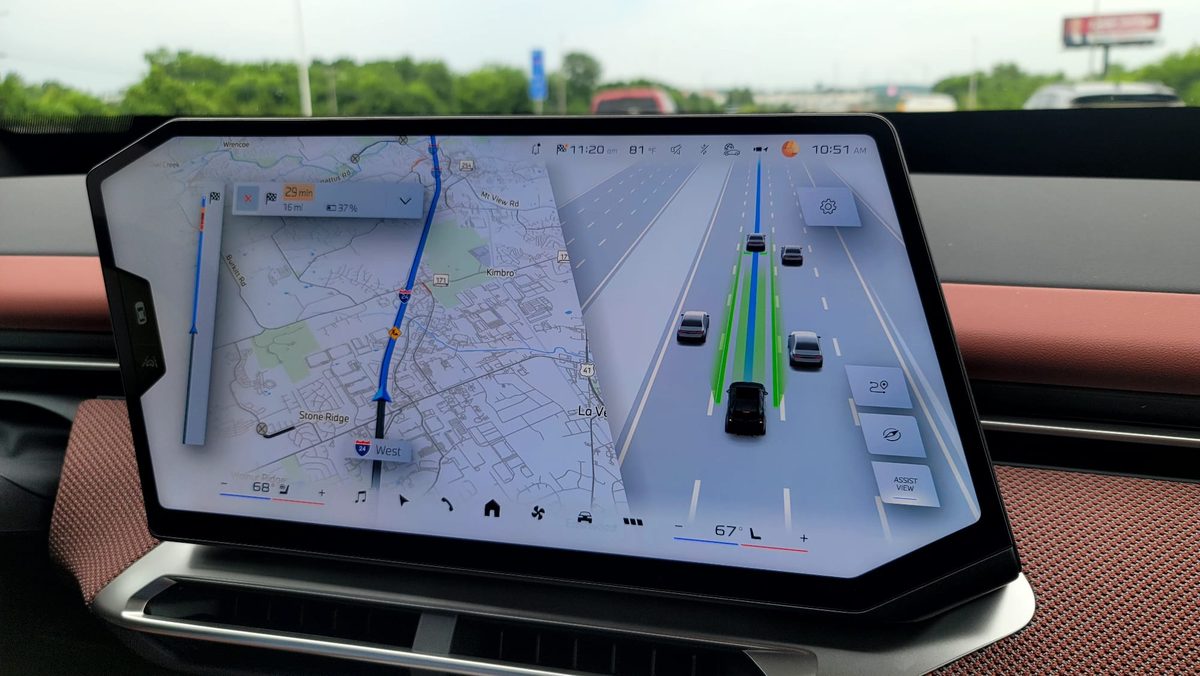 The BMW iX3 central display showing 3D navigation alongside the driver-assistance Assist View